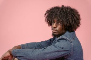 serious black man in denim jacket in studio